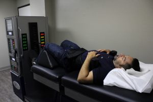 A man at Vitality Integrative Wellness receiving spinal decompression therapy