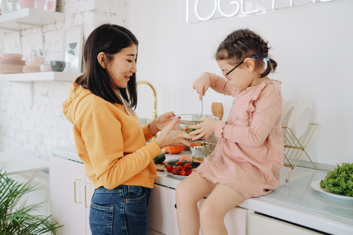 A mom and daughter making a healthy, delicious meal together. Diet is a major factor in immune system wellness. 
