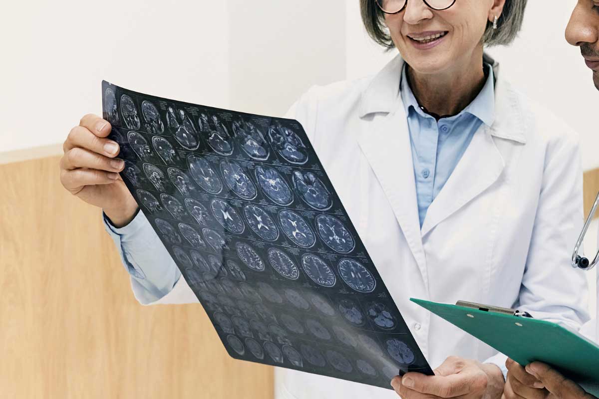 Blood Sugar Management 1 A doctor looking at brain scans of a diabetic patient. Diabetes is a risk factor for stroke.