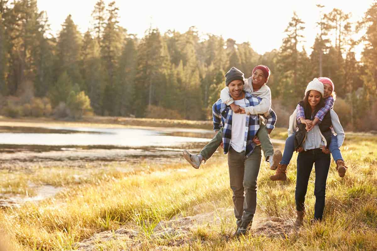 Unleashing the Power of Mind-Body Connection with Functional Medicine 2 A family going on a hike together by a beautiful lake.