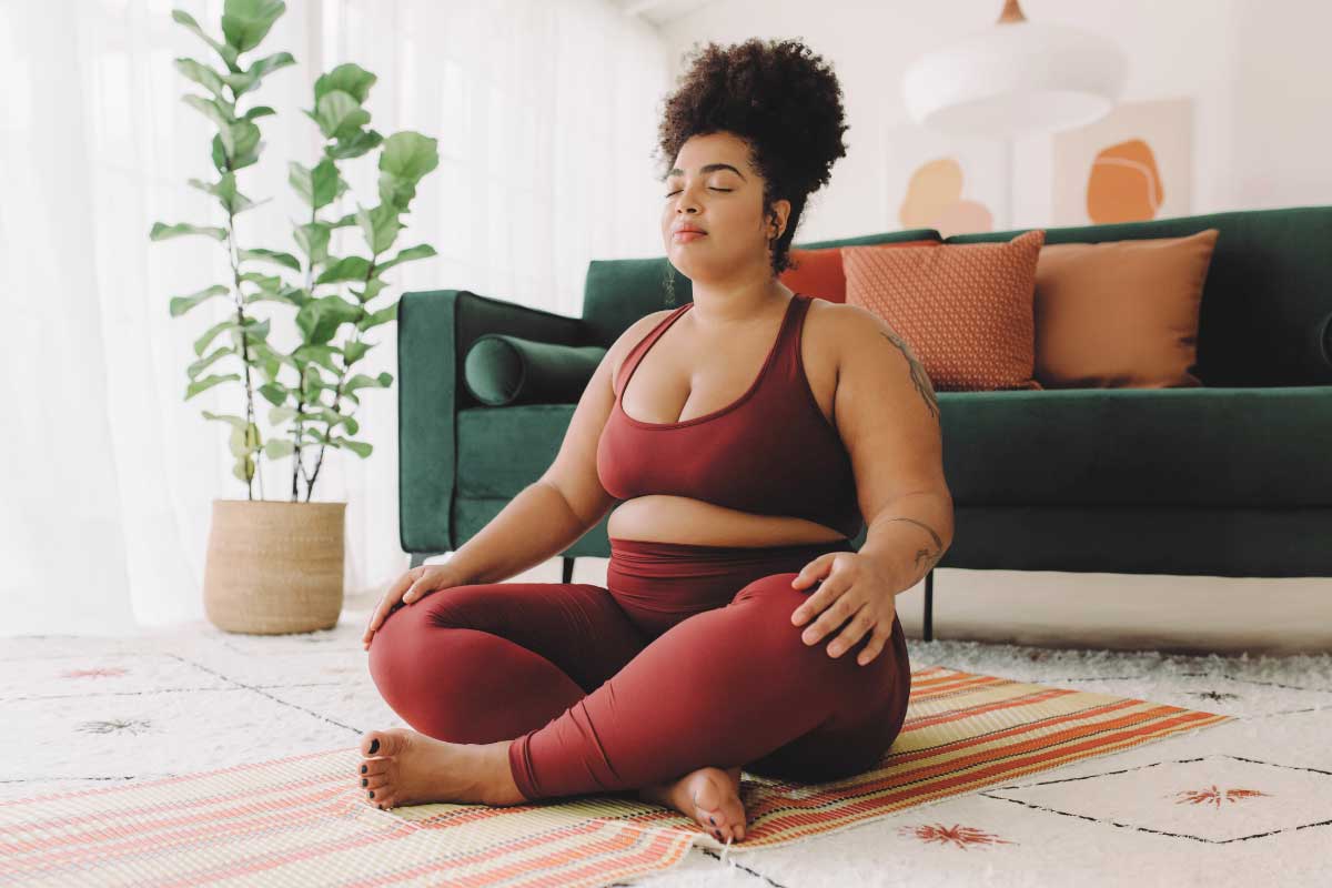 Weight Management Functional Medicine 3 A woman practicing meditation to relieve stress.
